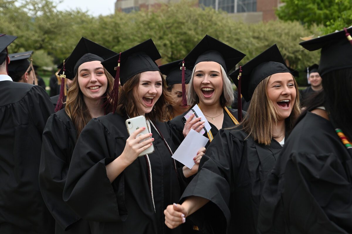 Four smiling graduates