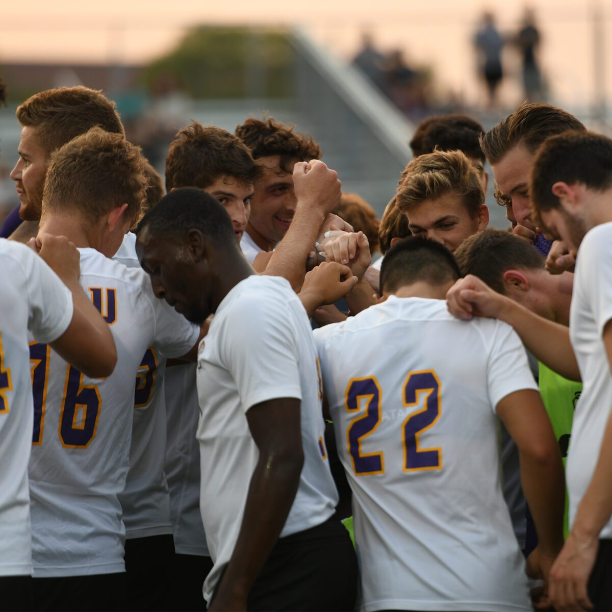 Soccer team huddles for prayer