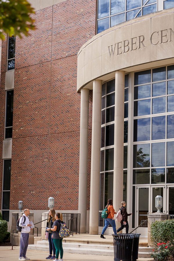 Group of students chatting outside of Weber Center