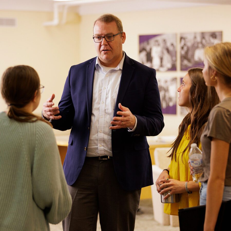 male prof speaking with students