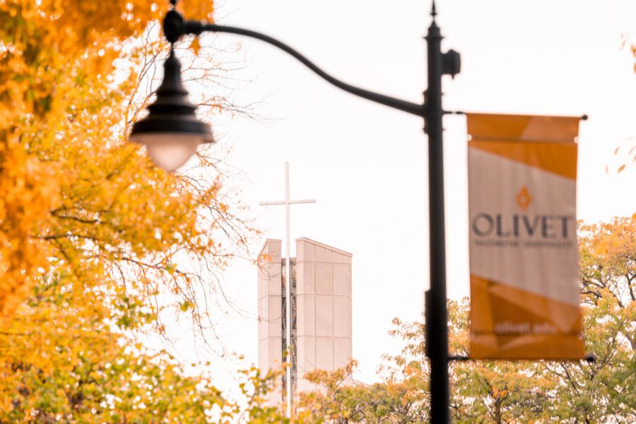 centennial chapel and Olivet banner next to a tree with orange leaves