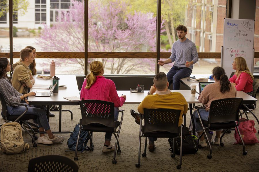 students learning in front of library windows