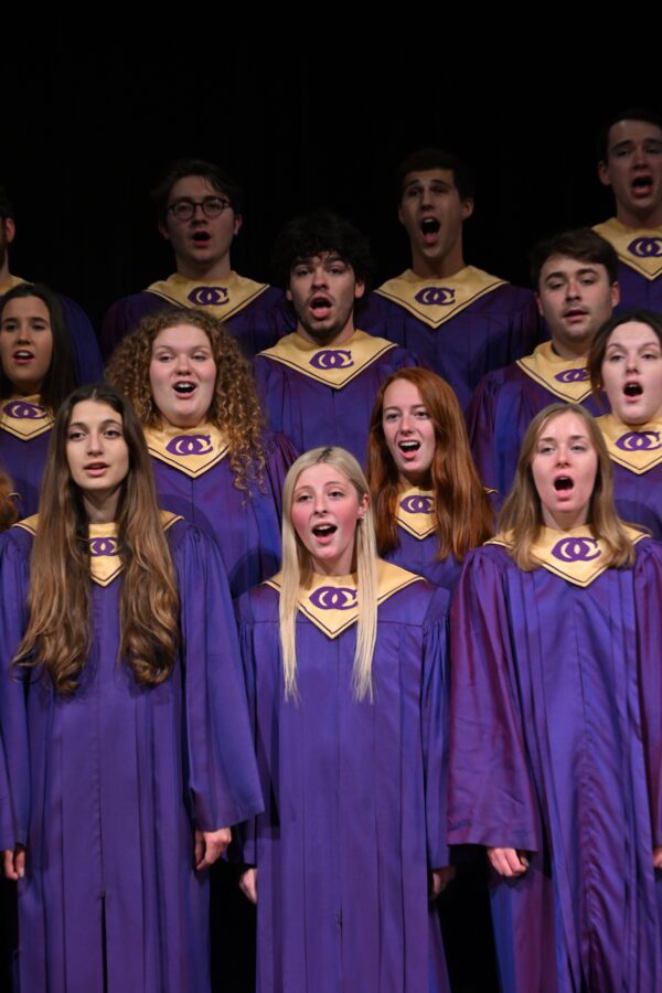 Students in purple choir robes singing