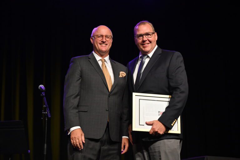 Lance Kilpatrick accepting award from Gregg Chenoweth