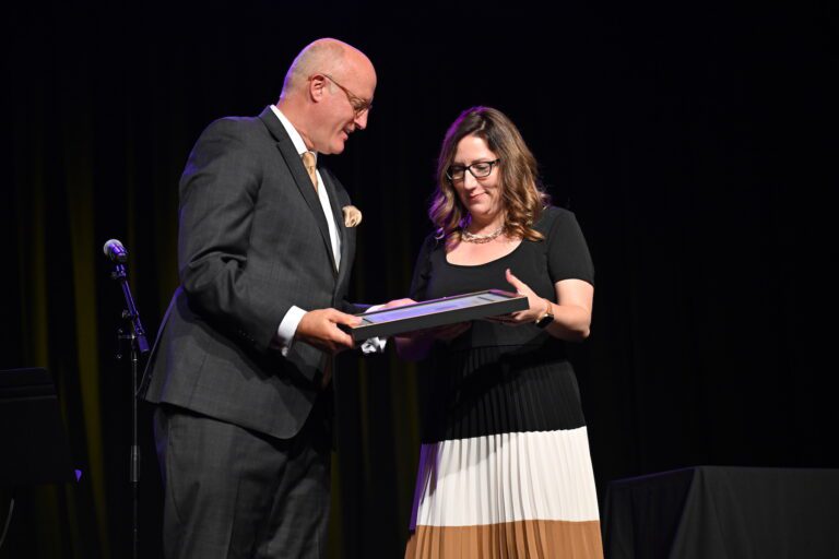 woman accepting award on stage