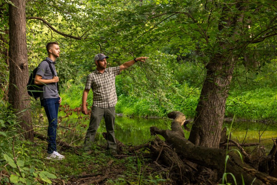 two men at a nature preserve studying wildlife