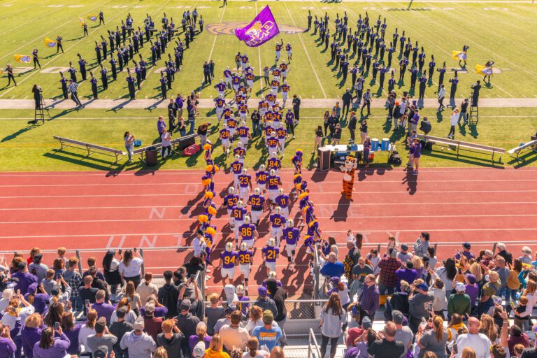 Football players running. out on the field