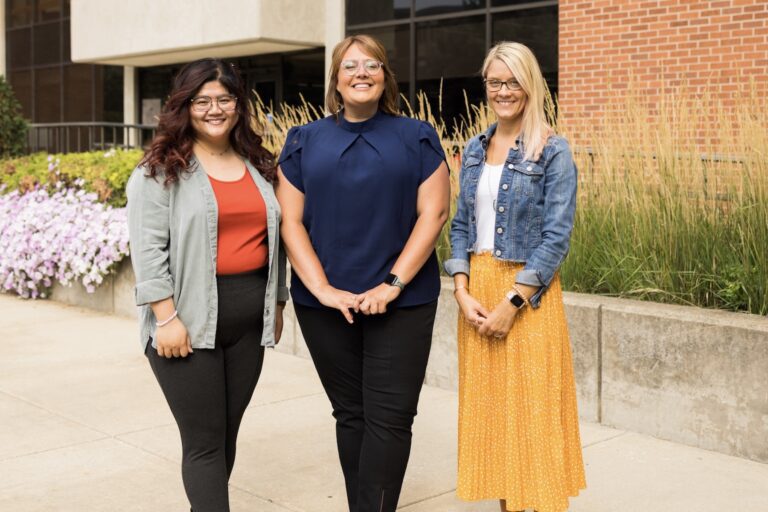 Academic Support Staff standing outside