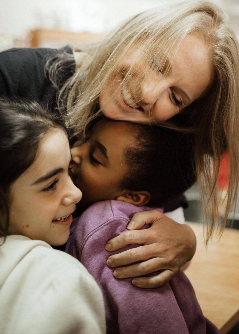 Amanda CHoi hugging group of kids in Israel
