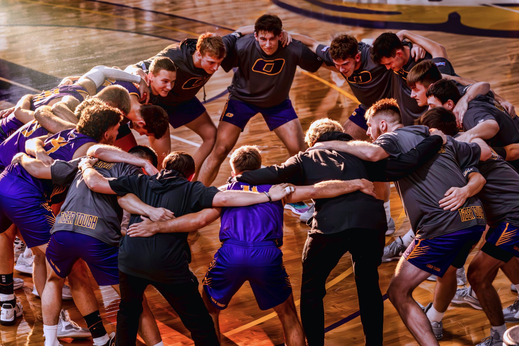The Olivet Men's basketball team huddles up in a circle before the game starts.