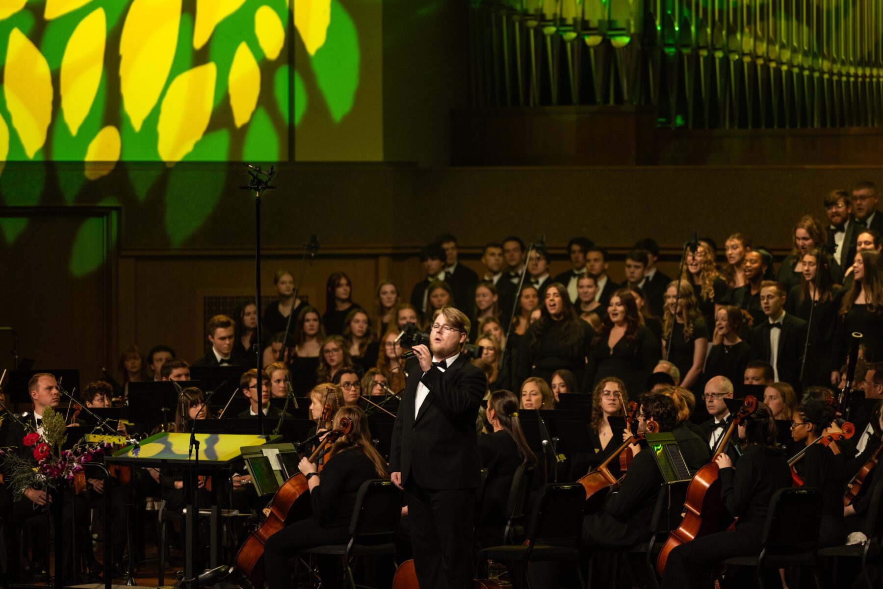 A soloist reaches out as he sings for the homecoming concert.