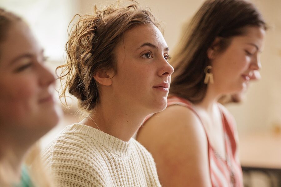 three females sitting in class