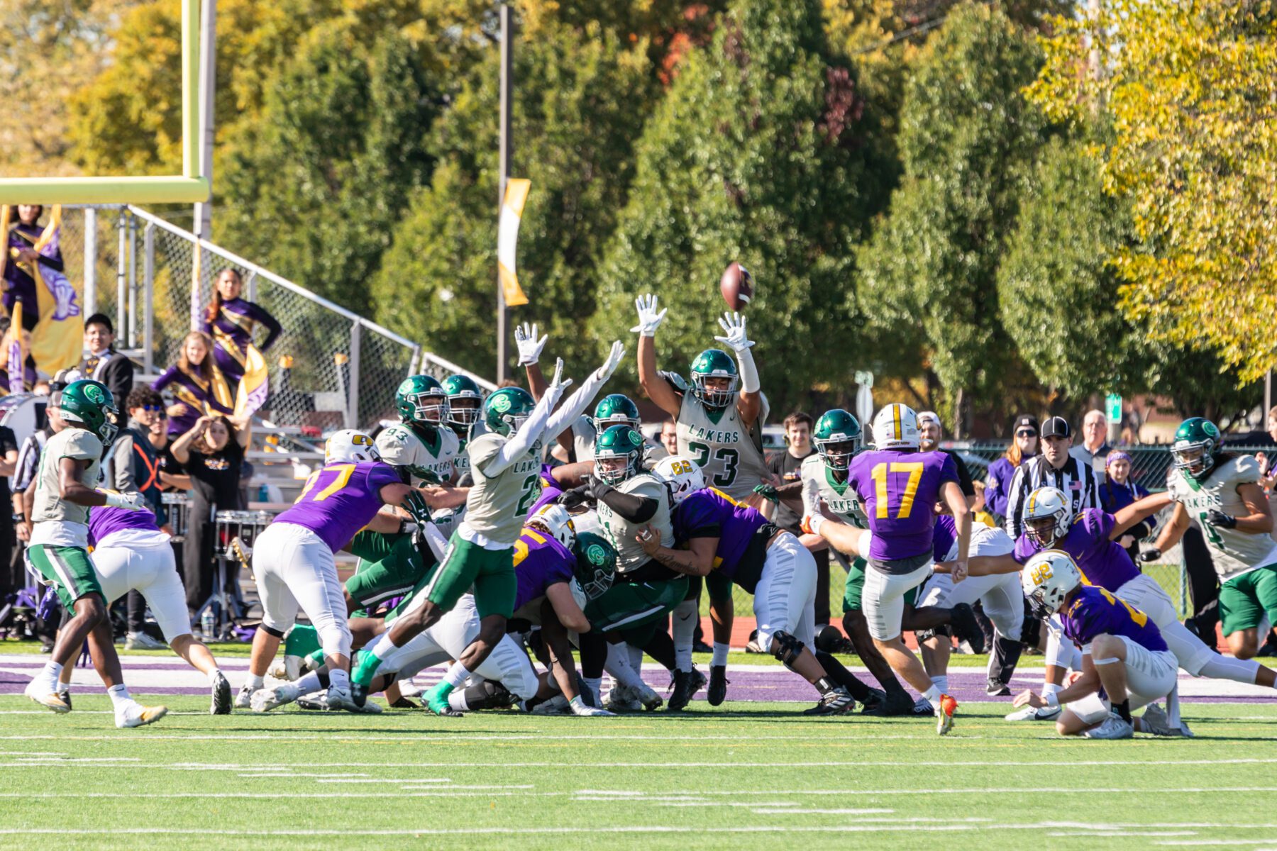 Olivet kicks a field goal while opposing team tries to block.