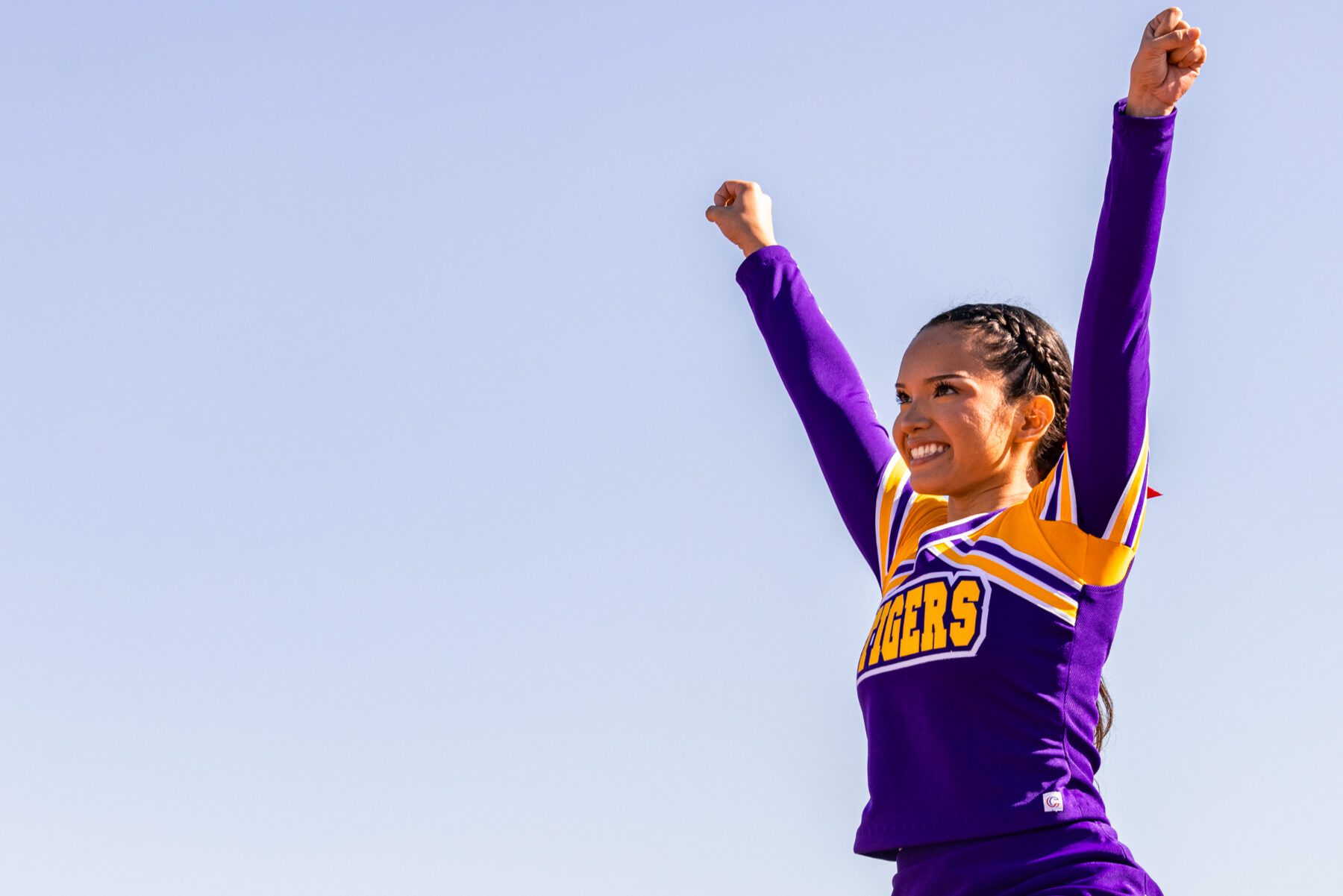 Olivet Cheerleader silhouette in the sky.