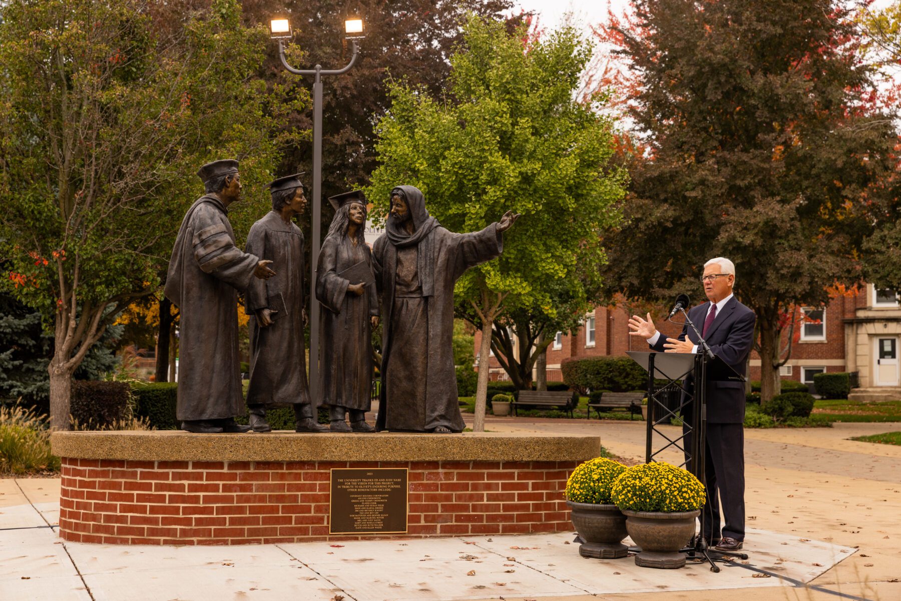 Ed Nash speaks to those who came for the unveiling of the new statue on campus.
