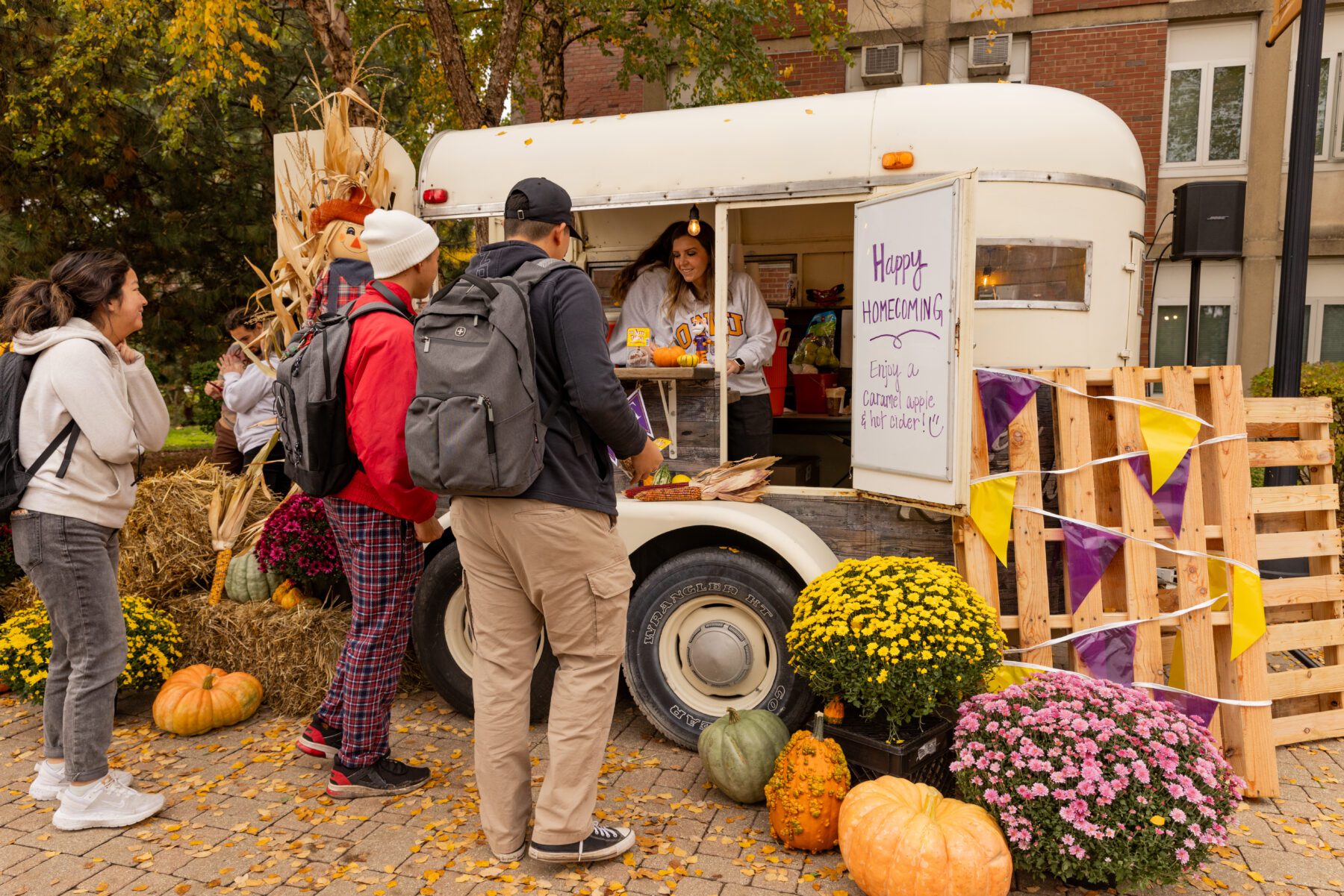 Students at Olivet line up in the Quad for candy apples.