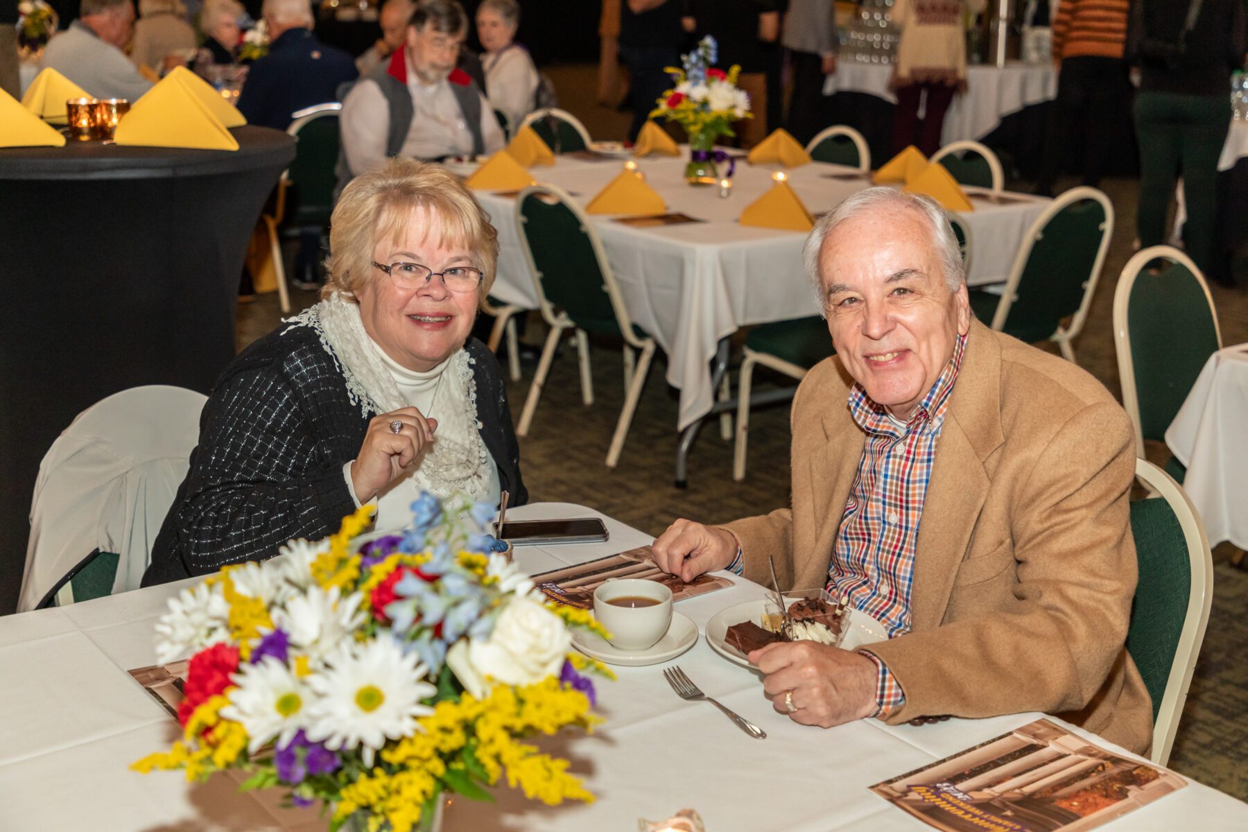 A couple smile at the camera while enjoying their Taste of Olivet.
