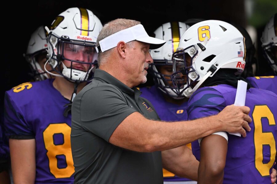 Coach Conway talking with football player