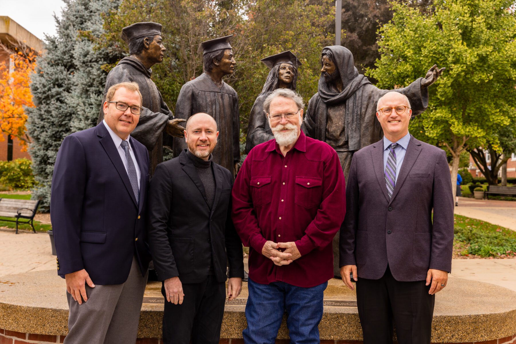 A group photo of architect Dale Jerome, artist Jon Seals, sculptor Scott Stearman, and president Gregg Chenoweth.
