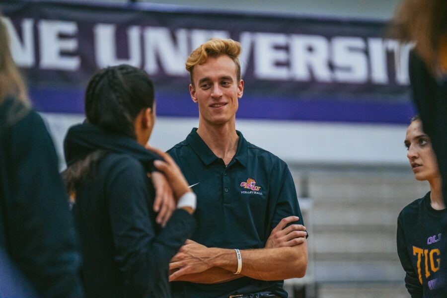 new women's volleyball coach crossing arms