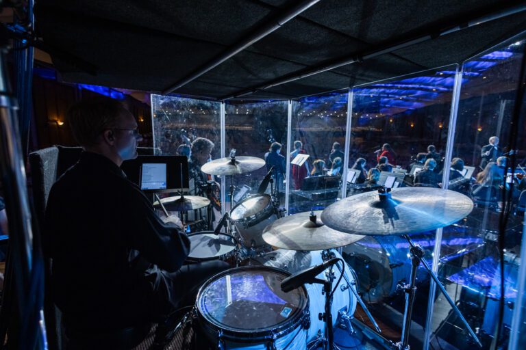 male professor in drum cage