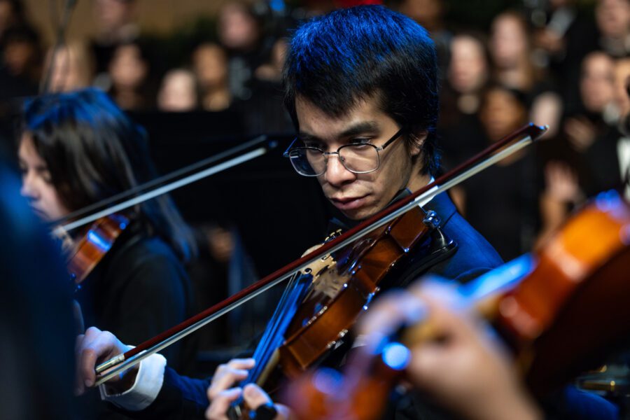 male student playing violin