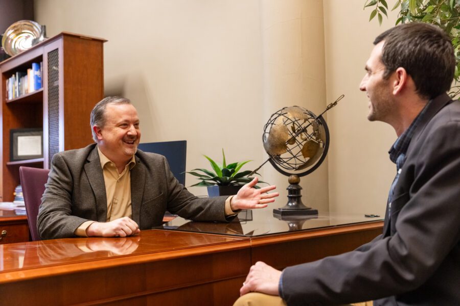two men chatting in an office