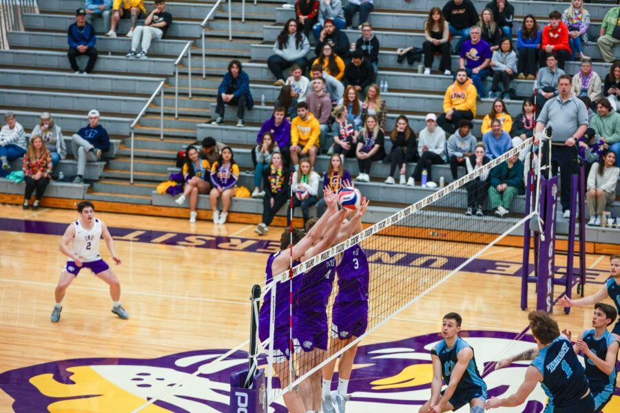 ONU men's volleyball team blocks at the net