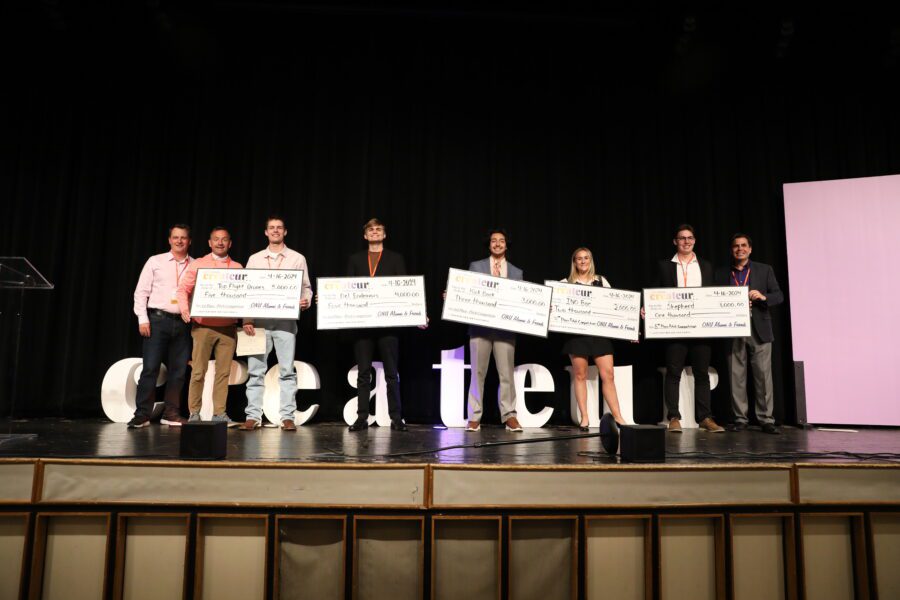 students with large checks winners Createur Pitch competition