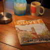 magazine on desk with mug and candle