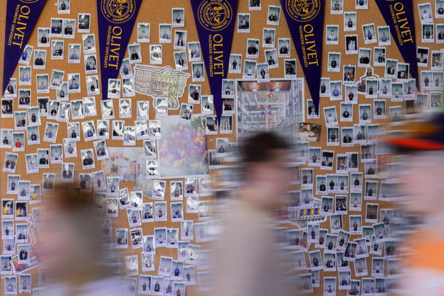 Students walking past the visit board in Admissions at ONU