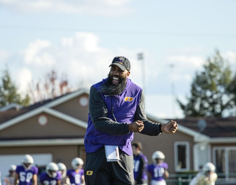 ONU Head Coach Avante Mitchell, selected by the Black College Football Hall of Fame, cheers on his team during football practice.