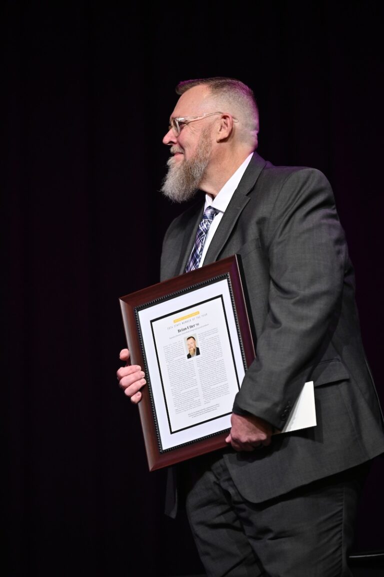 Brian Utter holding award