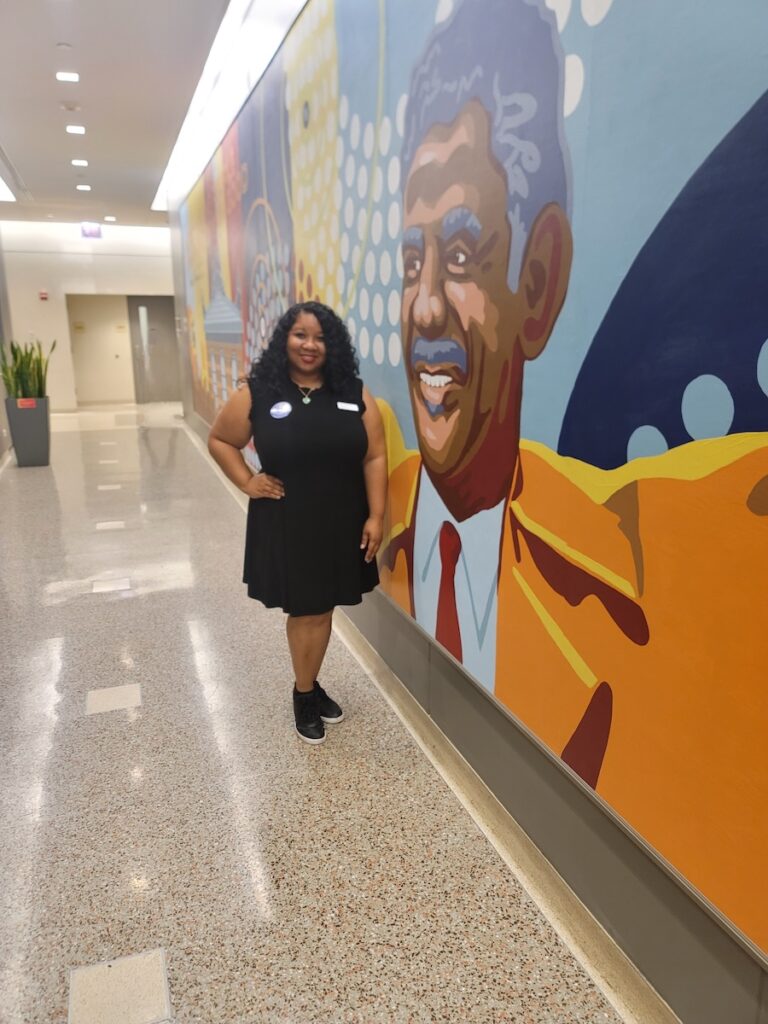 Linh Trang Williams in front of mural