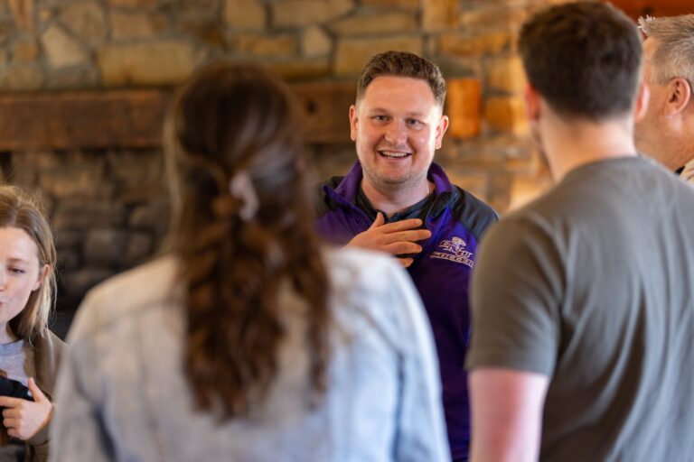 Soccer coach speaking with alumni