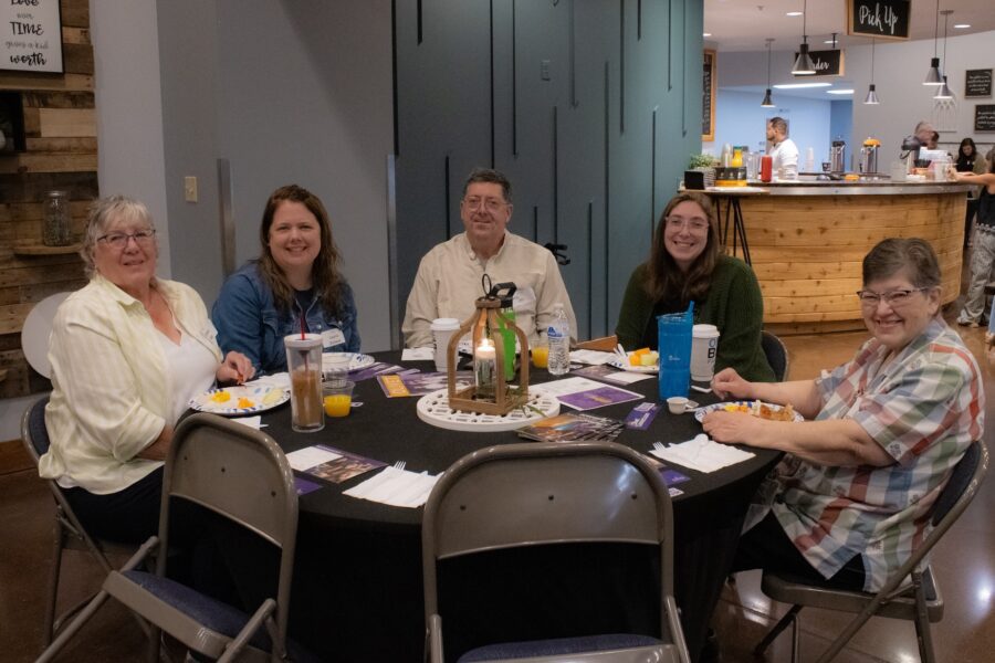 Alumni sitting at a table