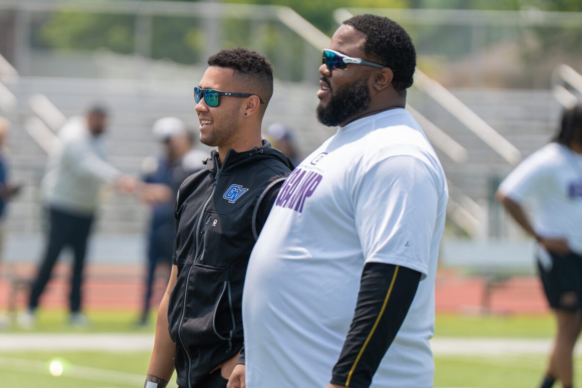 Grand Valley State University coach and former University of Michigan and Seattle Seahawks player Khalid Hill observe drills at the 2025 Avante Mitchell Football Mega Camp at Olivet Nazarene University