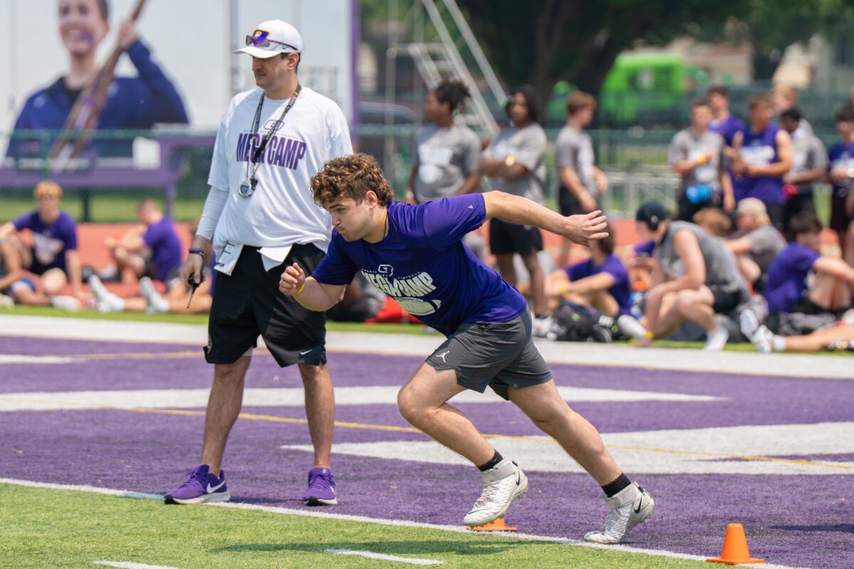 Athlete launches into a sprint drill as a coach observes during the 2025 Avante Mitchell Football Mega Camp at Olivet Nazarene University


