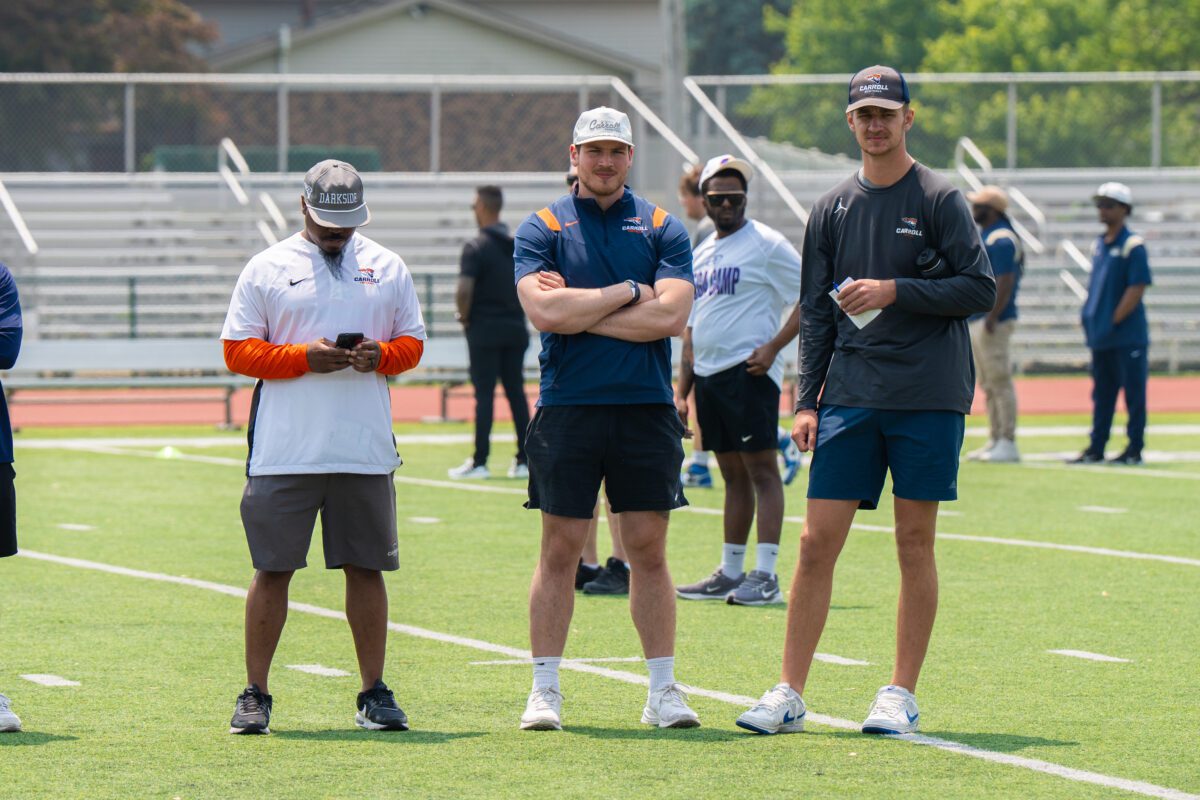 Coaches from Carroll University observe athletes during drills at the 2025 Avante Mitchell Football Mega Camp at Olivet Nazarene University
