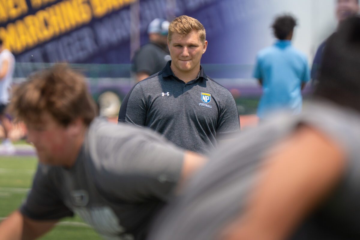 North Park University football coach observes linemen during drills at the 2025 Avante Mitchell Football Mega Camp at Olivet Nazarene University

