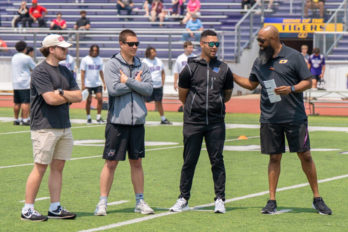 Coaches from University of Northern Iowa, Southern Illinois University, Grand Valley State University, and Olivet Nazarene University gather on the field during the 2025 Avante Mitchell Football Mega Camp

