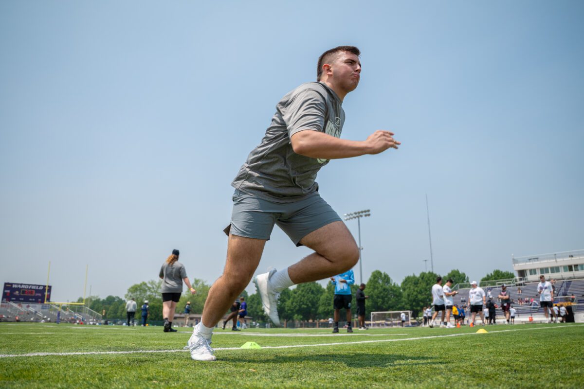 Athlete accelerates through a cone agility drill during the 2025 Avante Mitchell Football Mega Camp at Olivet Nazarene University