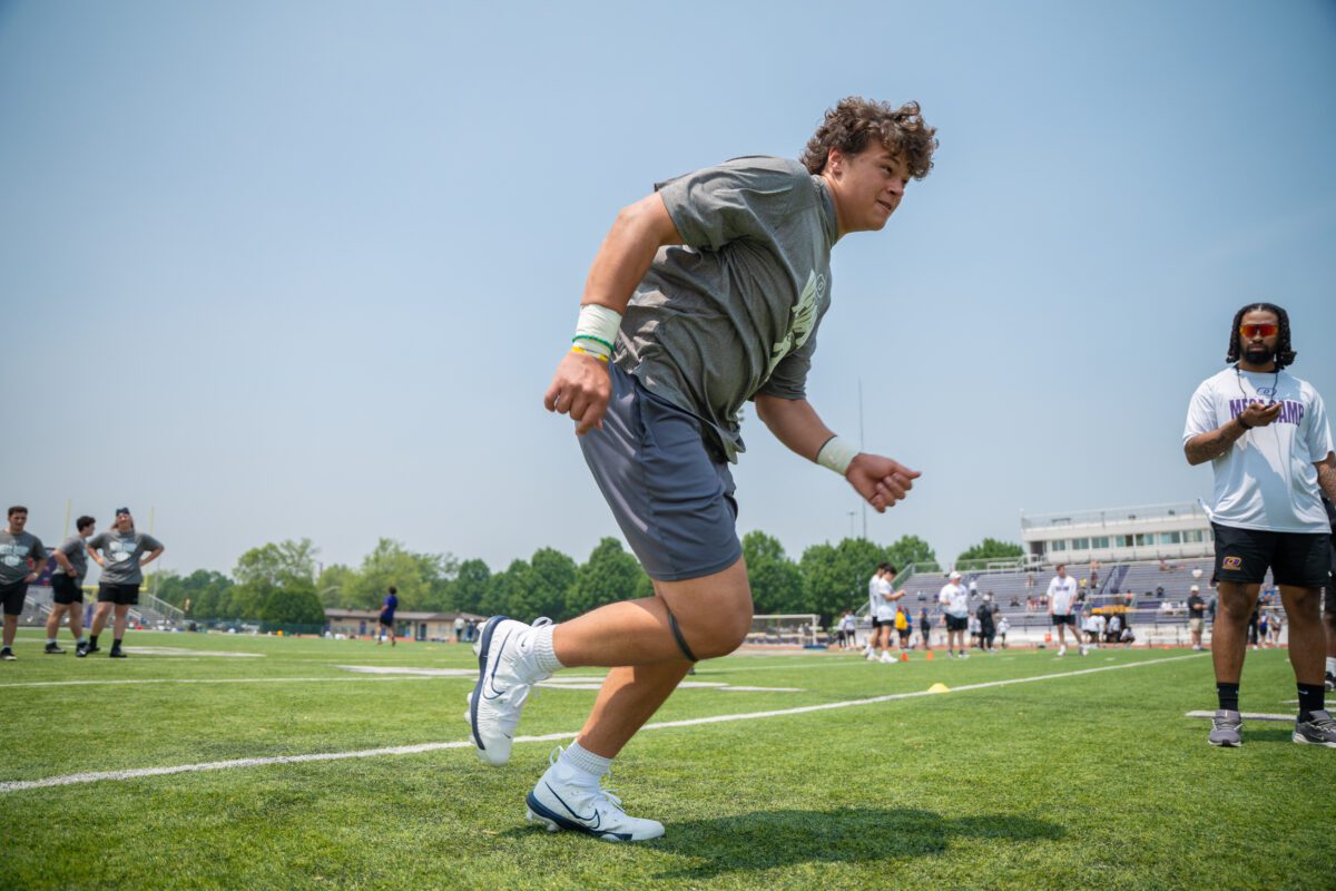 Athlete performs a lateral movement drill while coaches evaluate technique at the 2025 Avante Mitchell Football Mega Camp at Olivet Nazarene University.