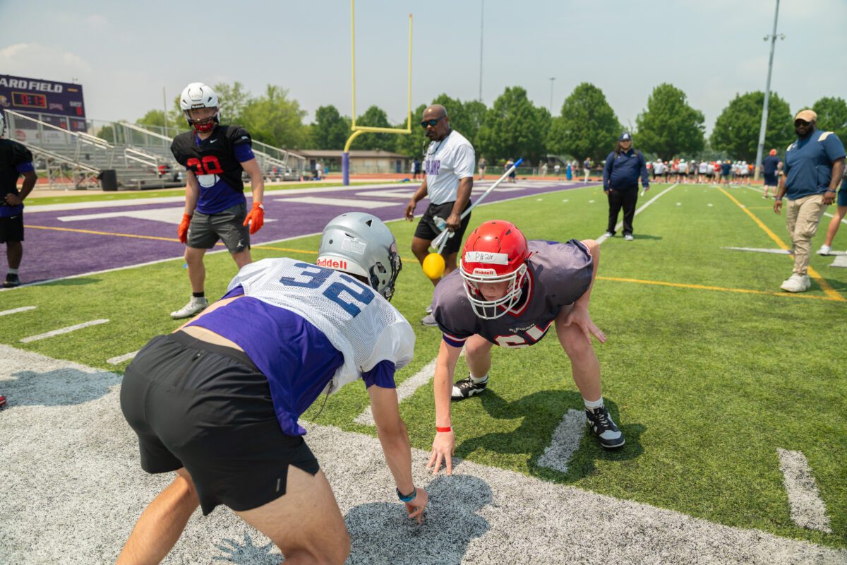 Players face off in a one-on-one drill while coaches supervise at the 2025 Avante Mitchell Football Mega Camp at Olivet Nazarene University

