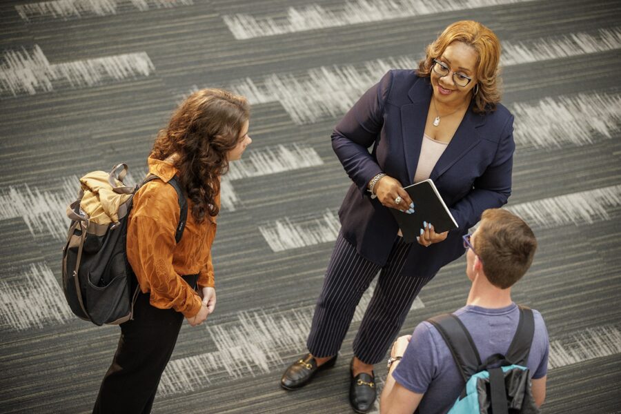 female professor speaking with two students