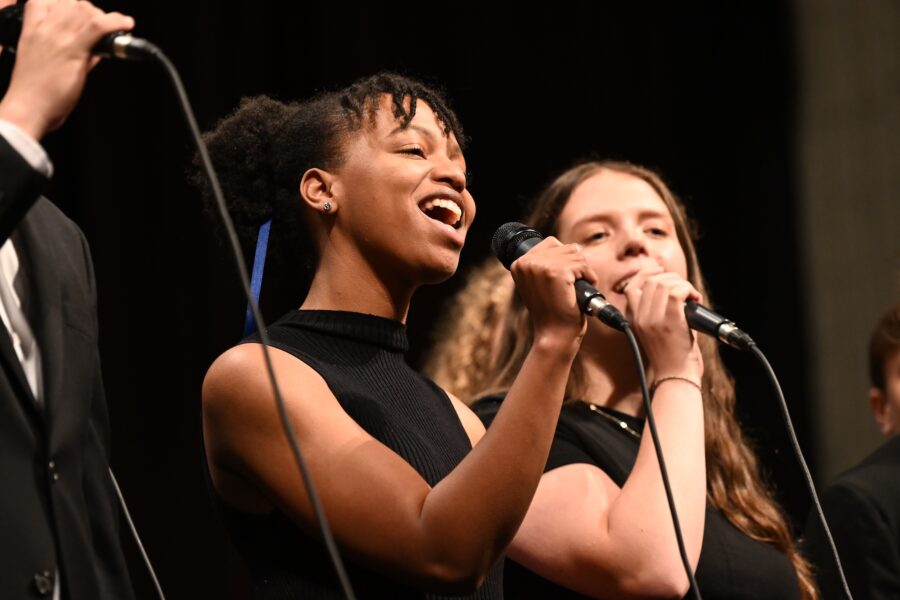two girls holding a microphone and singing