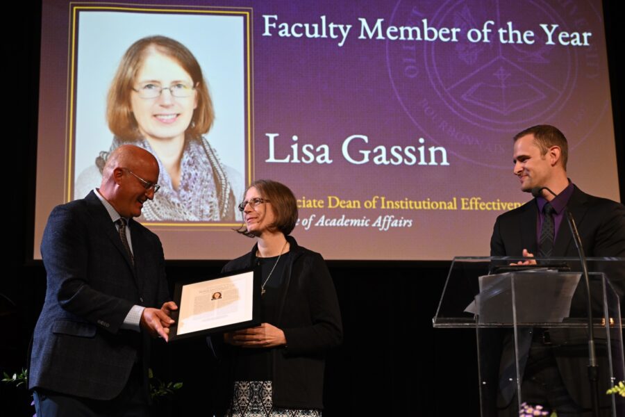 Lisa Gassin accepting an award on stage