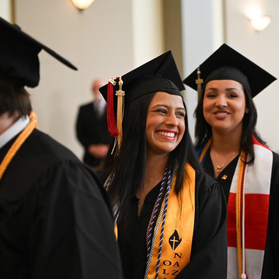 female smiling before graduation ceremony