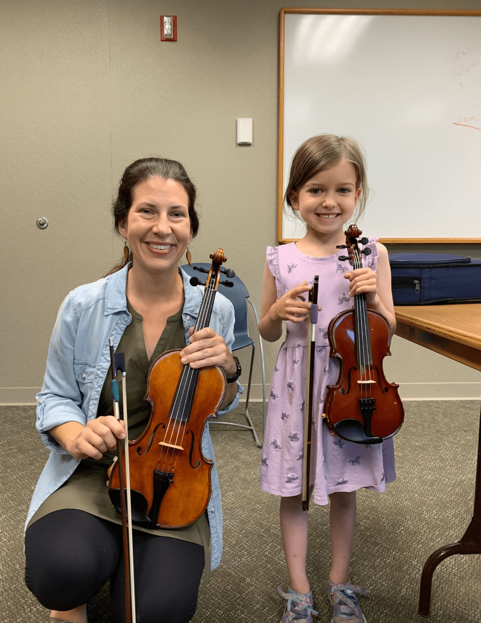 Laura Otto Standing with a violin student