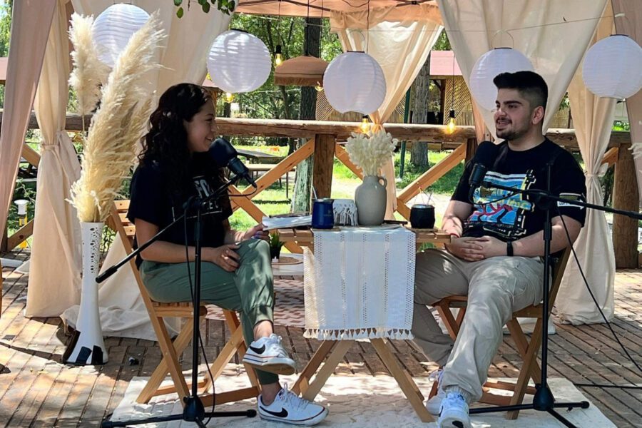 Man and a woman sitting at a table talking